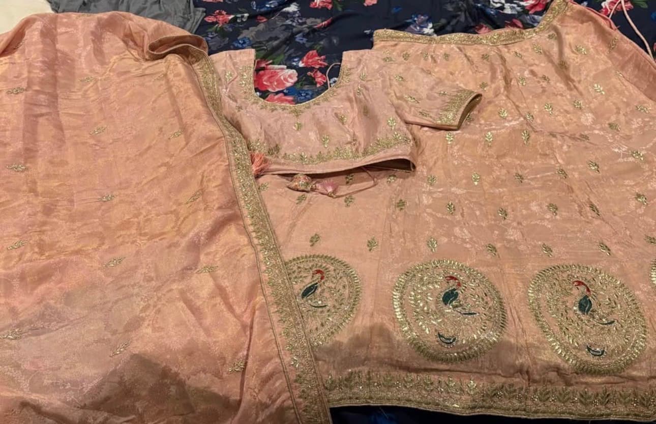 Elegant Peach Lehenga Choli with Gold Embroidery and Peacock Motifs