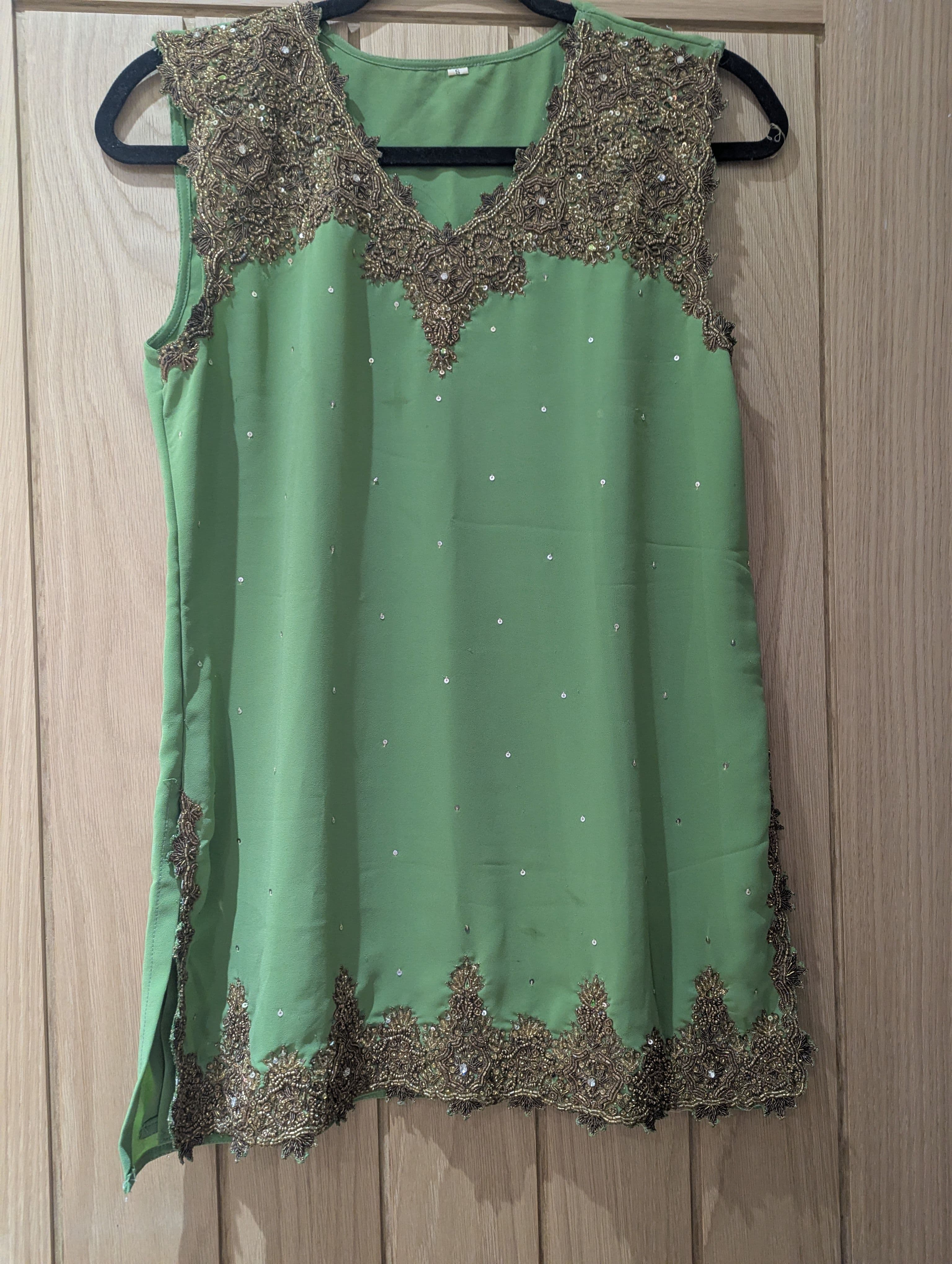 Elegant Green Sleeveless Salwar Suit with Intricate Gold Embroidery