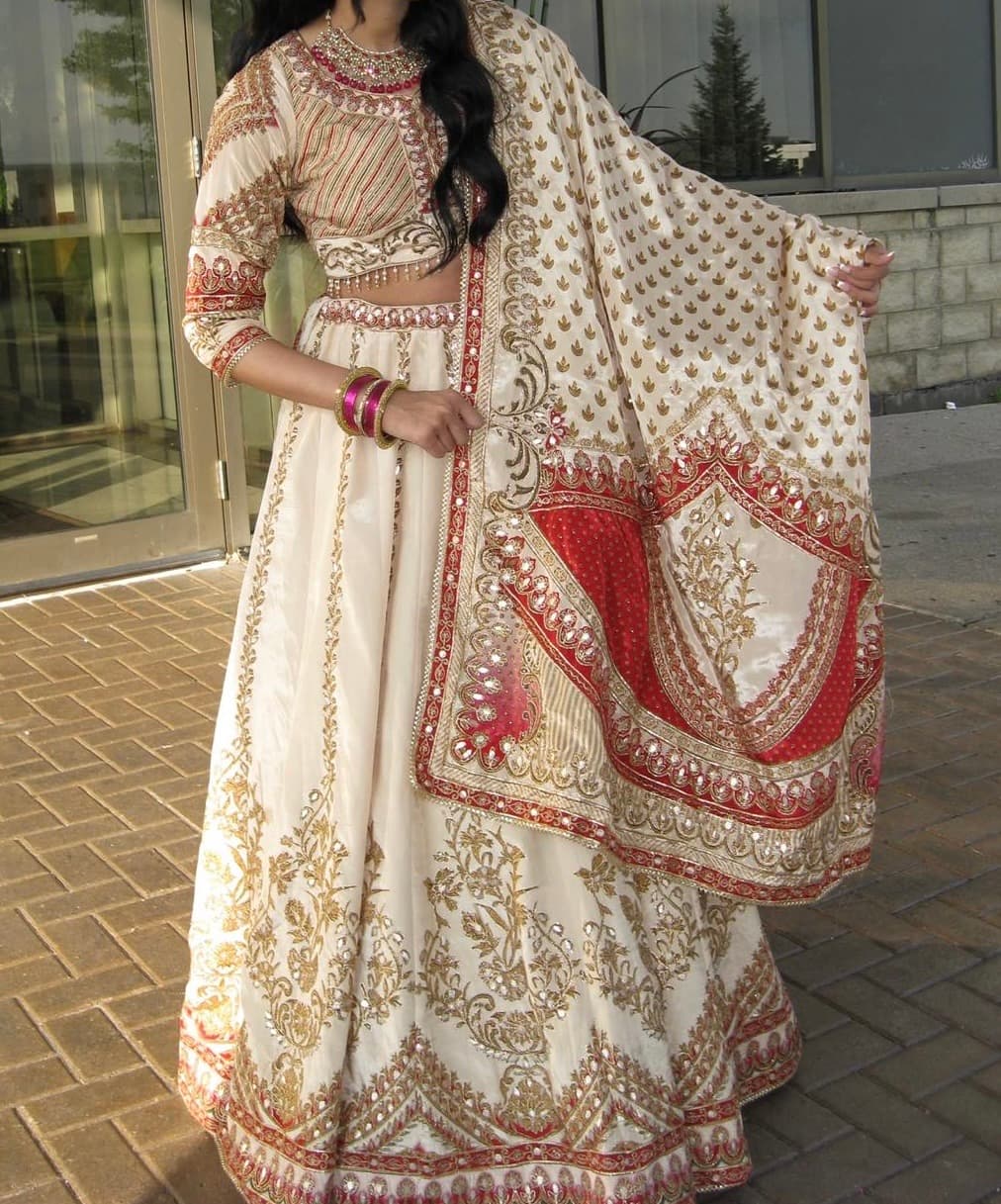 Elegant Cream & Gold Embroidered Lehenga with Red Accents