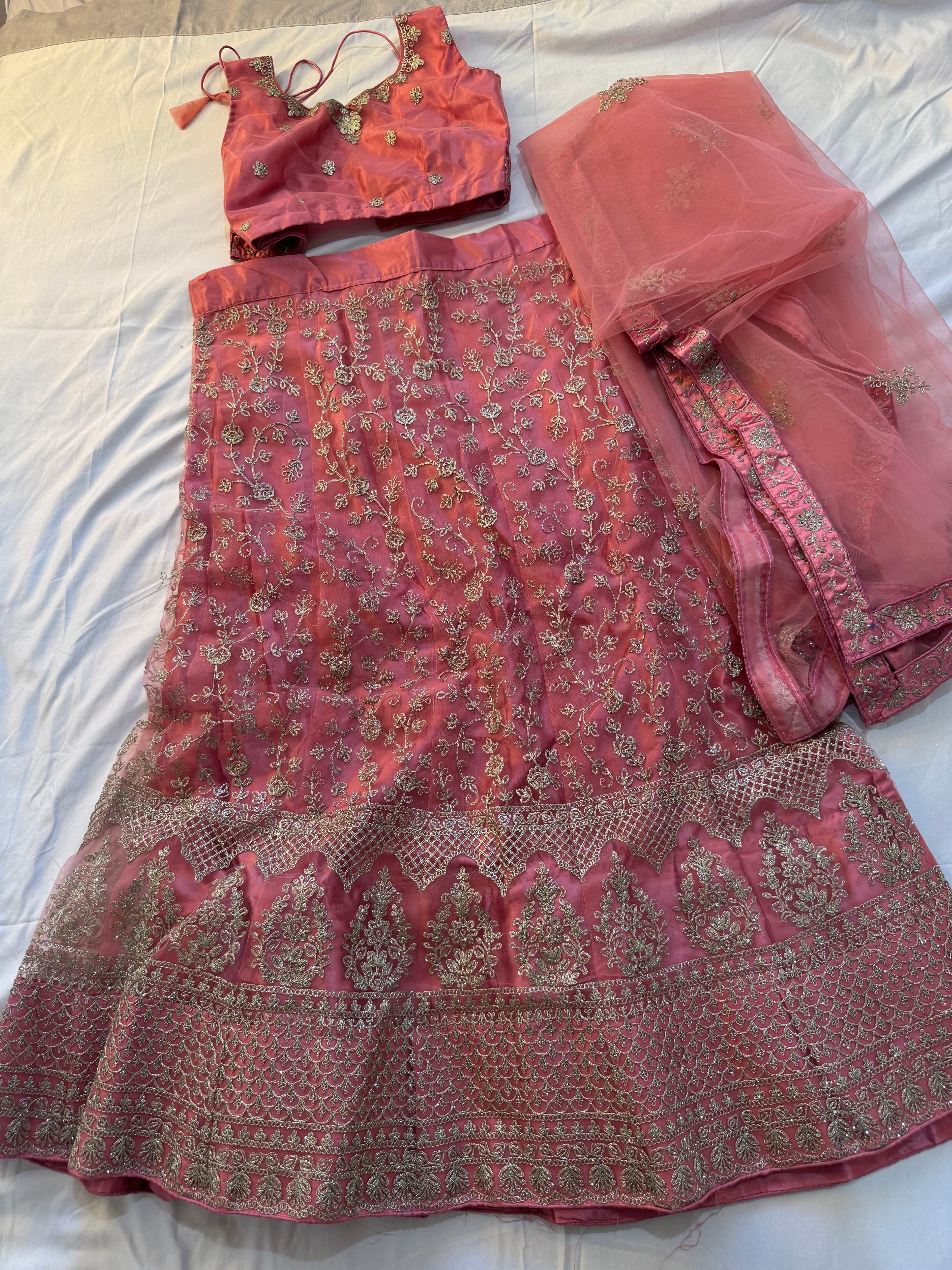 Elegant Pink Lehenga Choli with Intricate Gold Embroidery and Net Dupatta