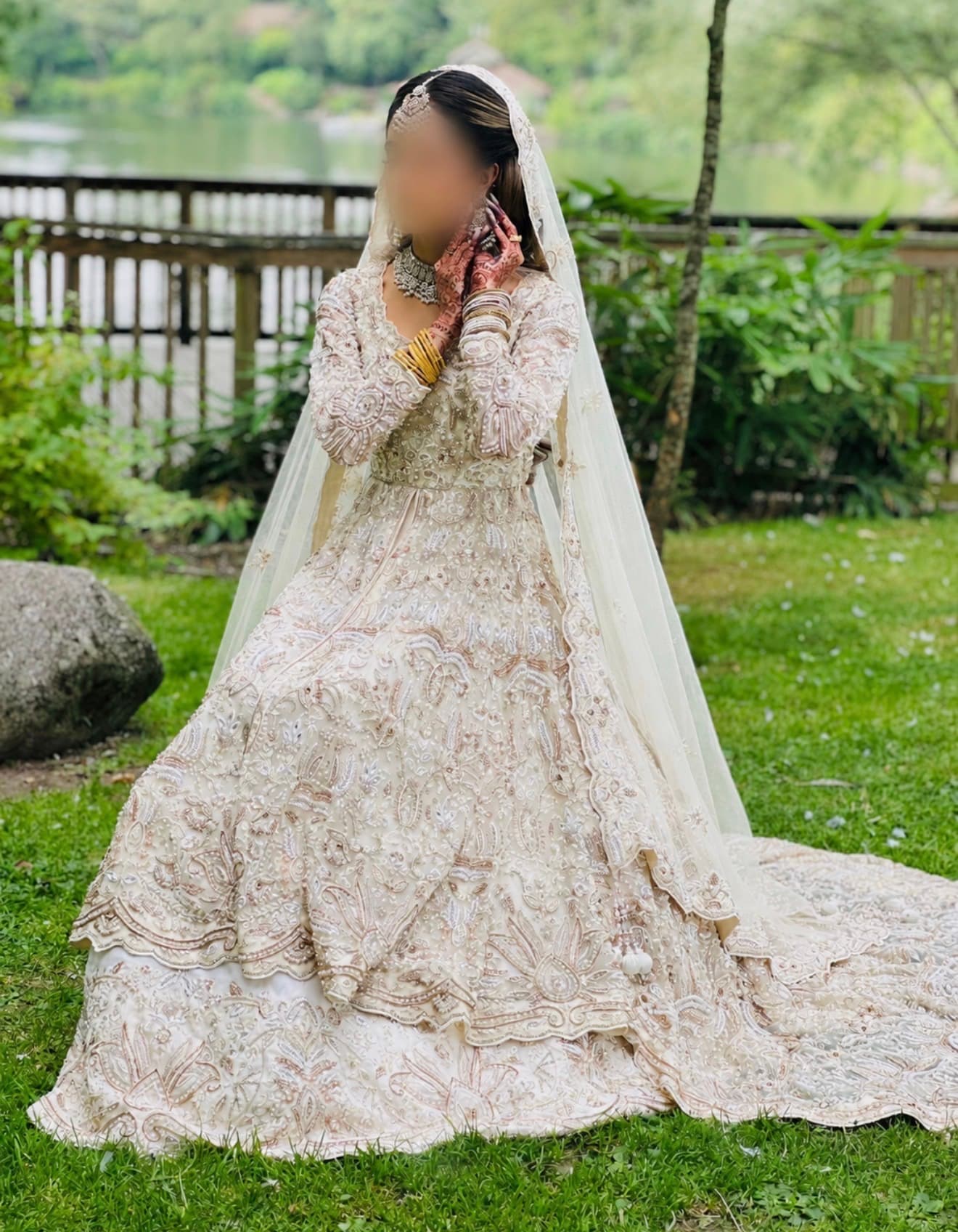Stunning Ivory and Gold Bridal Lehenga with Intricate Embroidery and Long Trail